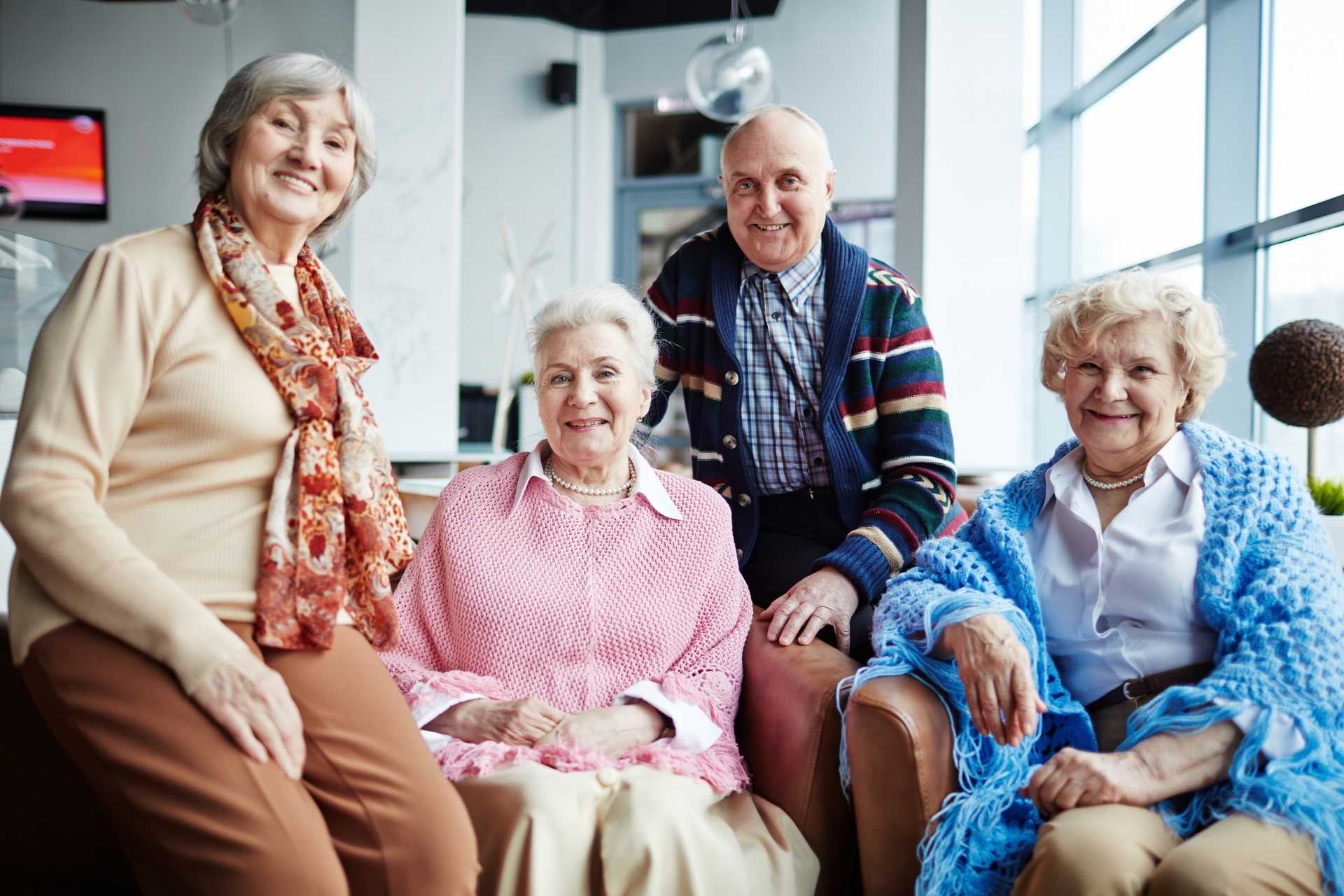 group of happy seniors posing together and smiling.